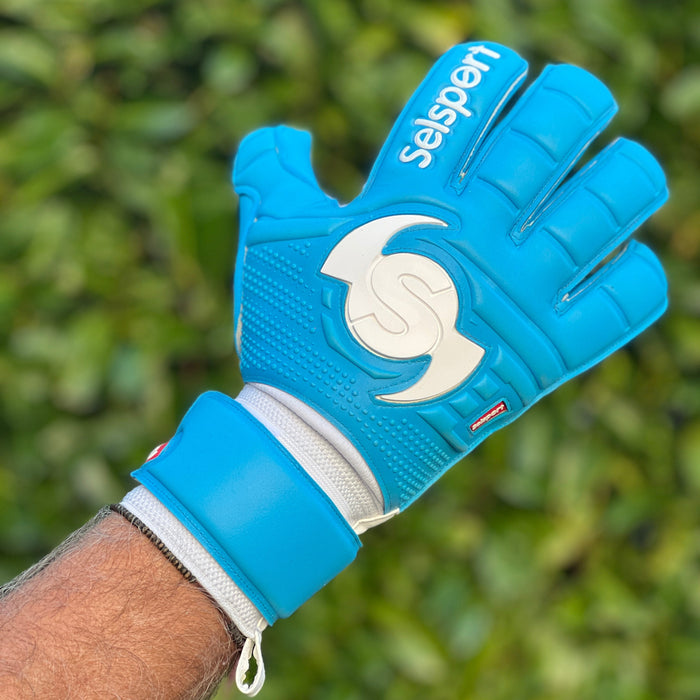 Blue sports glove with a brand logo on a blurred green background