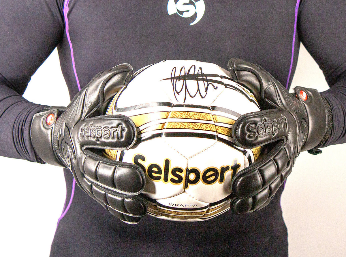Selsport Wrappa Classic Professional Rollfinger goalkeeperglove in all black with pro wrist strap holding a selsport football